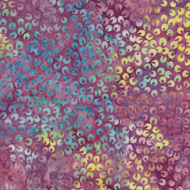 A mottled mauve batik fabric features scattered ocean blue and lime green petals. 