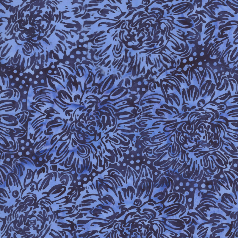 A indigo blue batik fabric with large blue dahlias. 