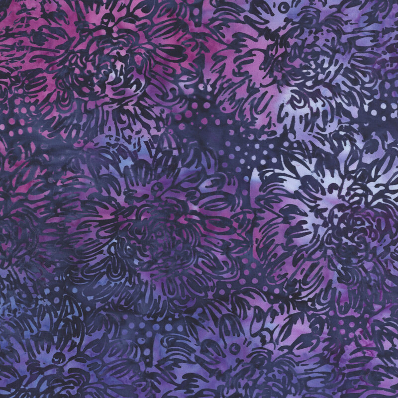 A mottled periwinkle and orchid batik fabric with large dark blue dahlias.