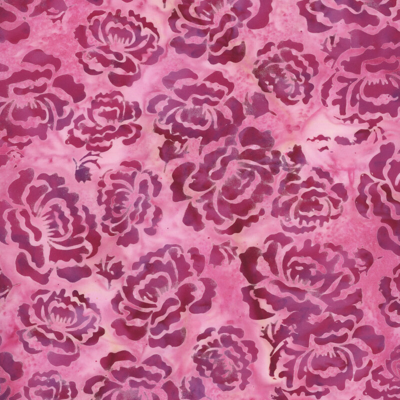 A mottled tea rose pink batik fabric with bright pink hollyhock flowers. 