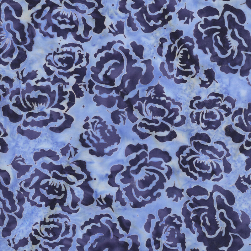 A mottled powder blue batik fabric with dark indigo blue hollyhock flowers. 