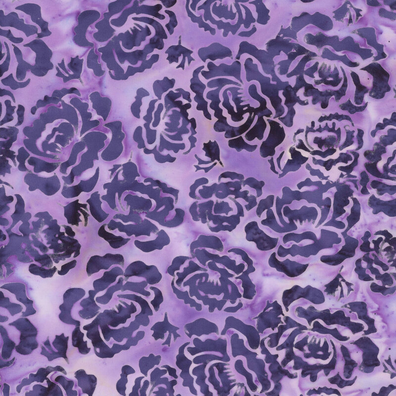 A mottled heather purple batik fabric with dark slate blue hollyhock flowers. 
