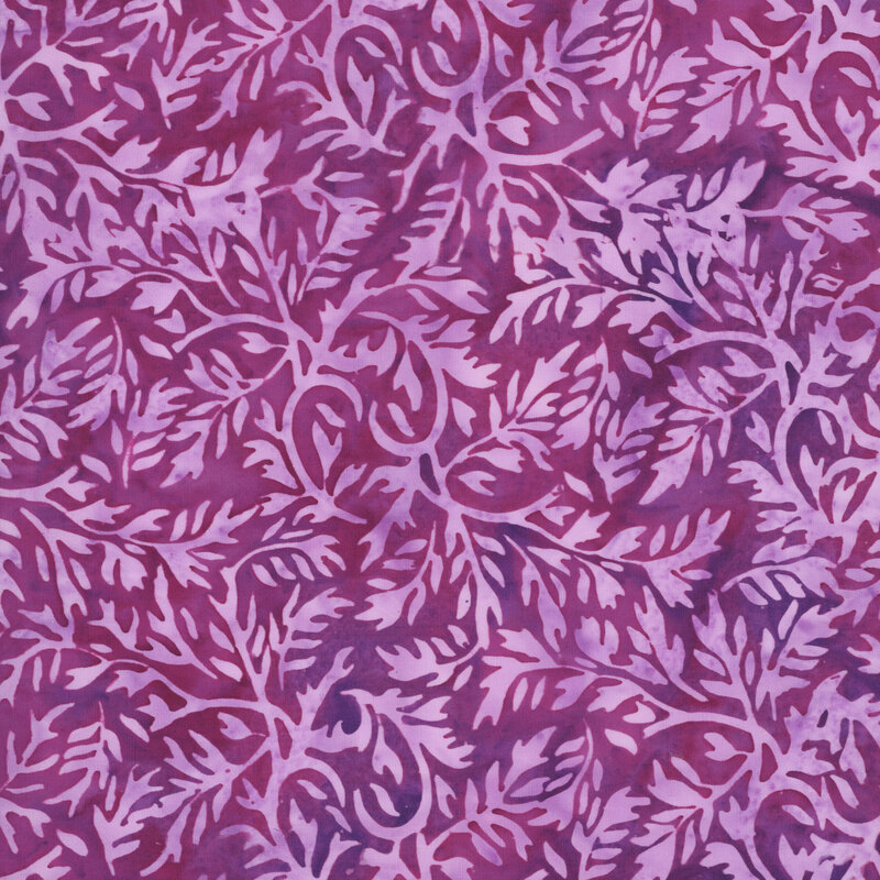 A mottled plum pink batik fabric with pink leaves.