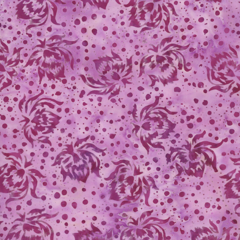 This mottled mauve pink batik fabric features orchid pink flower and dots.