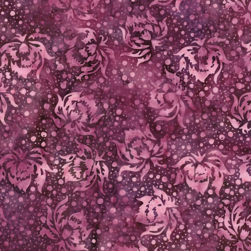 This mottled muted magenta batik fabric features tonal flower and dots.
