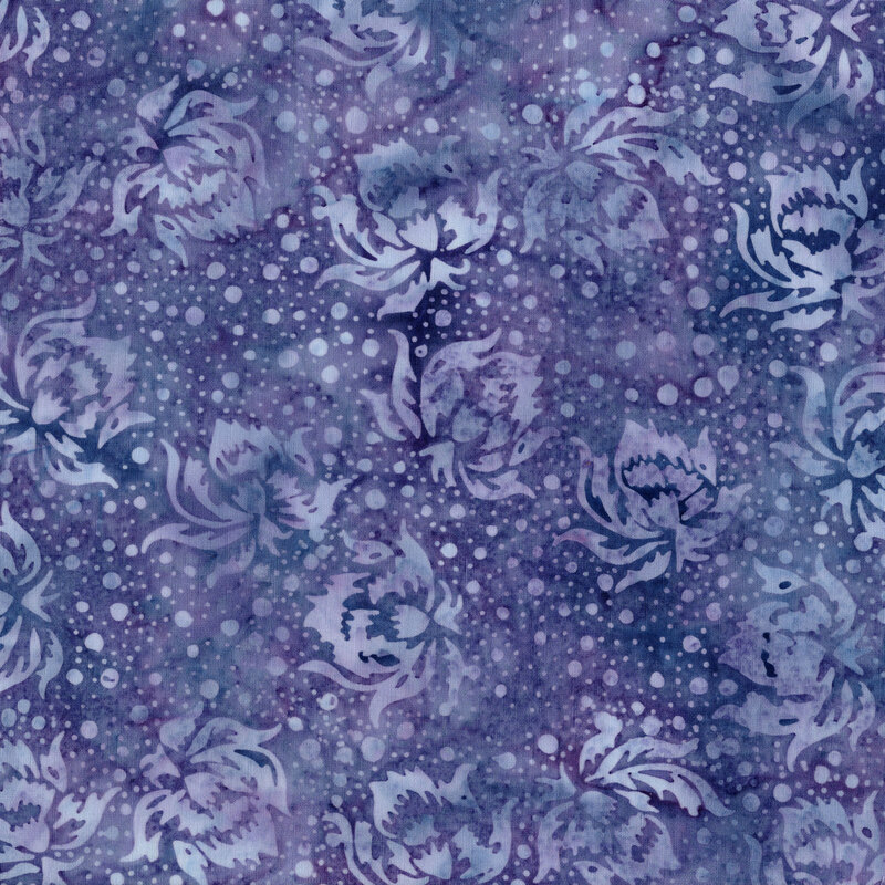 This mottled dark periwinkle batik fabric features tonal flowers and dots.