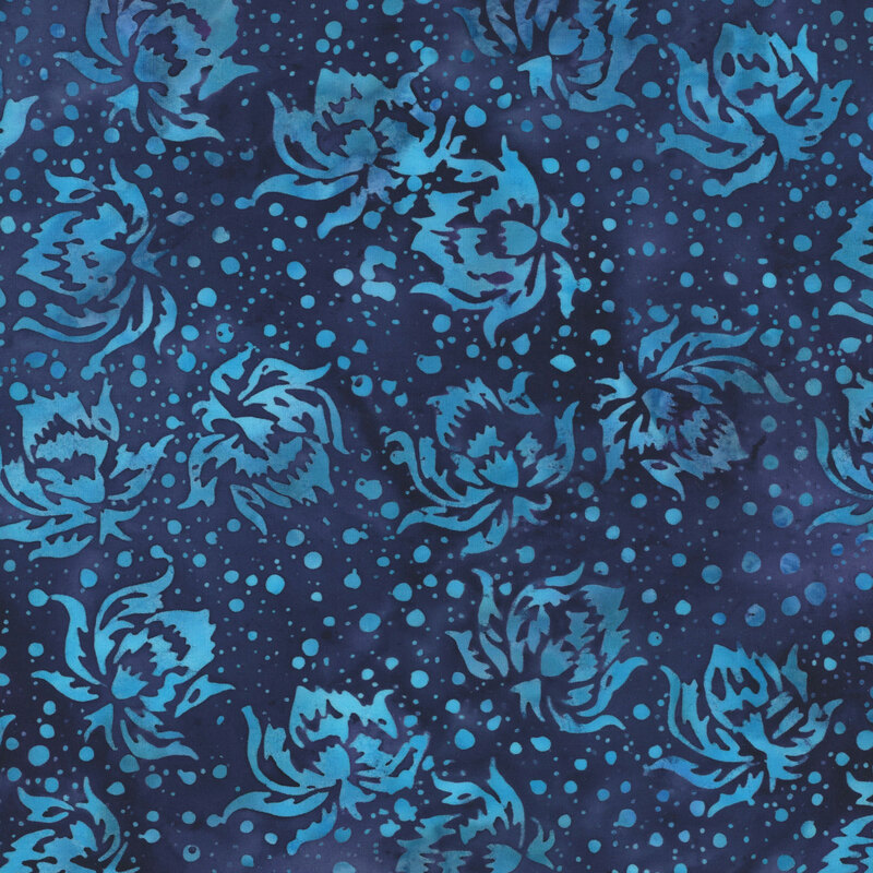 This mottled navy blue batik fabric features ocean blue flowers and dots.