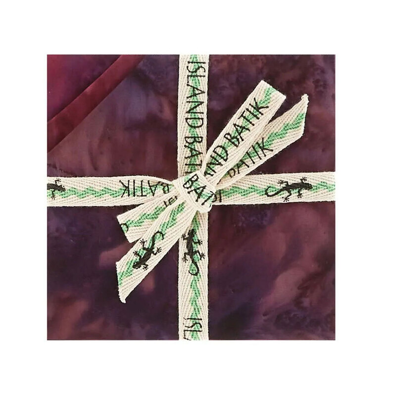 Image of the mottled purple 5" charm stack with tied with an "Island Batik" ribbon.