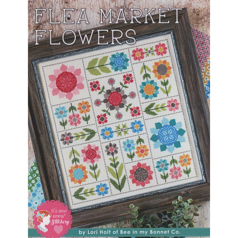 A framed quilt pattern titled Flea Market Flowers featuring colorful floral designs in a grid layout.