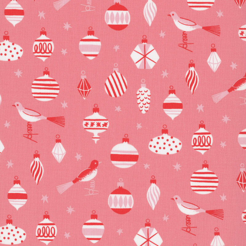 Salmon pink fabric featuring vintage style ornaments, birds, and stars in hues of red, cream, and blush.