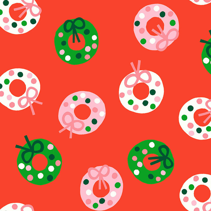 Scarlet red fabric featuring stylized wreath pattern in shades of green, white, and blush.