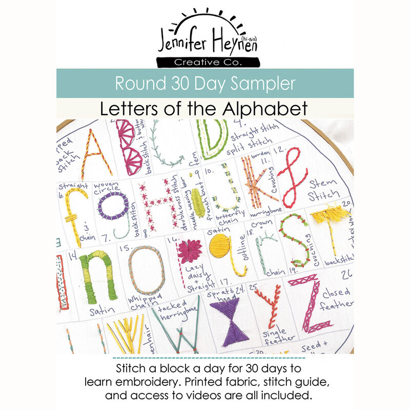 The front of the Round 30 Day Sampler - Letters of the Alphabet showing examples of completed embroidered blocks