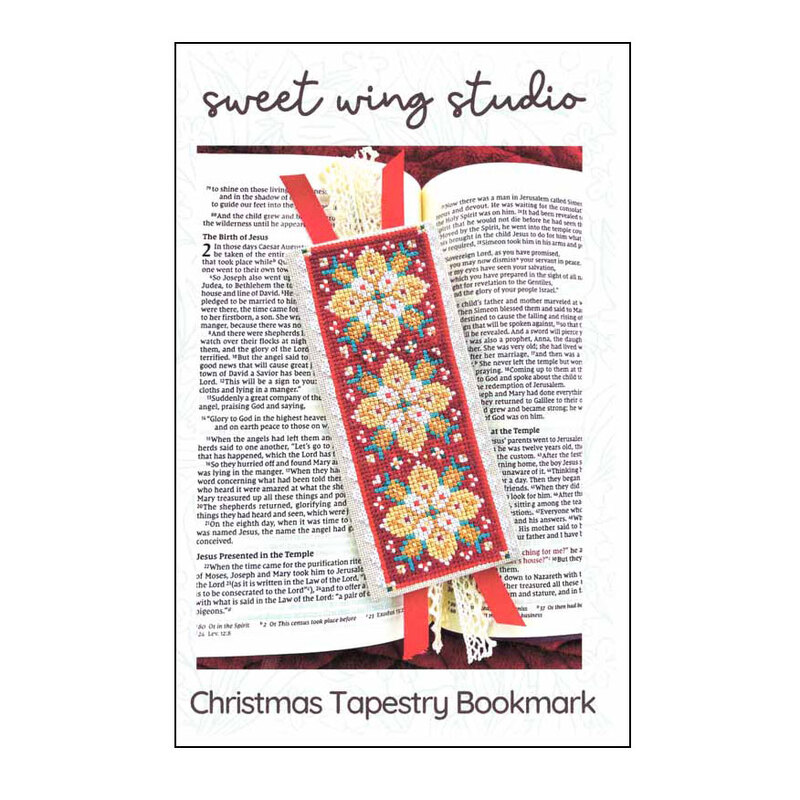 The front of the cross stitch pattern, showing the completed project on a book.