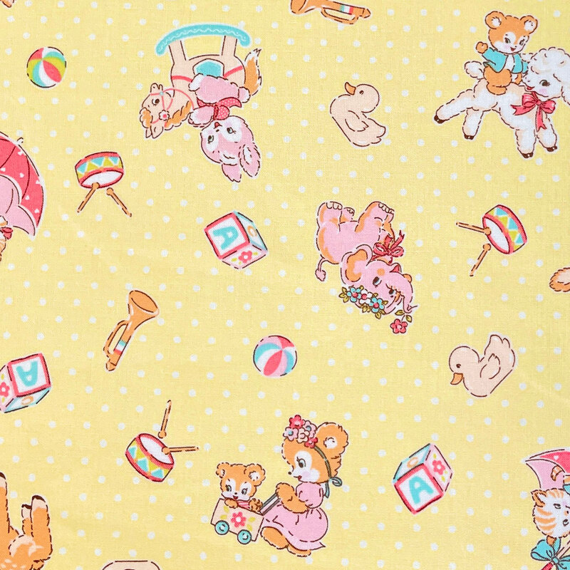 Light yellow fabric with a vintage-inspired design of cartoon animals and other childhood motifs scattered across a background of white dots.