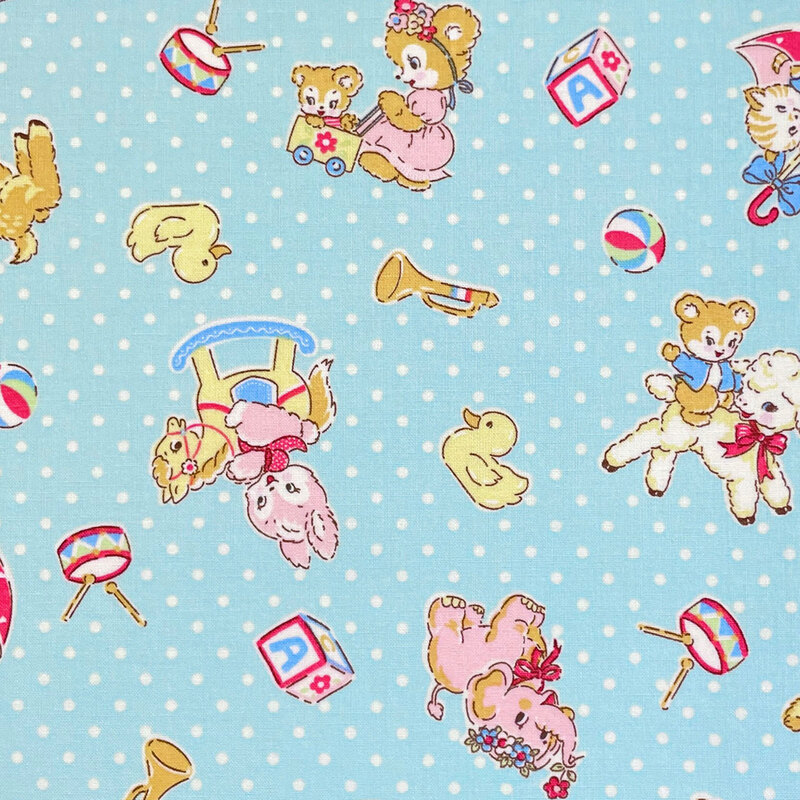 Light blue fabric with a vintage-inspired design of cartoon animals and other childhood motifs scattered across a background of white dots.