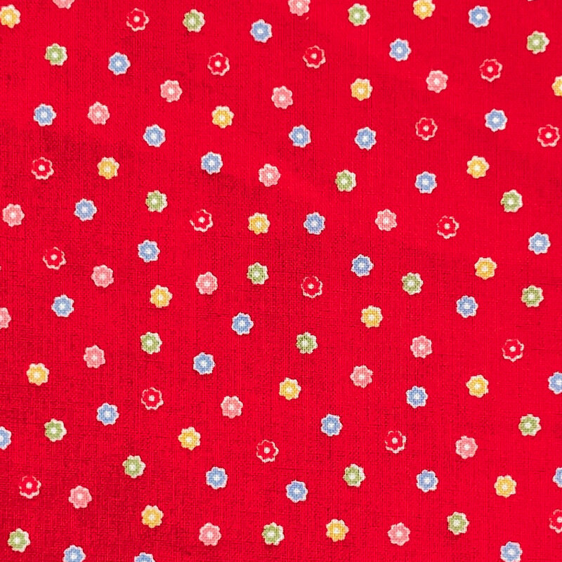 Bright red fabric with a scattered pattern of colorful flower buds.