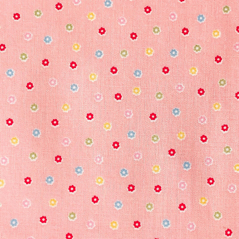 Pink fabric with a scattered pattern of colorful flower buds.