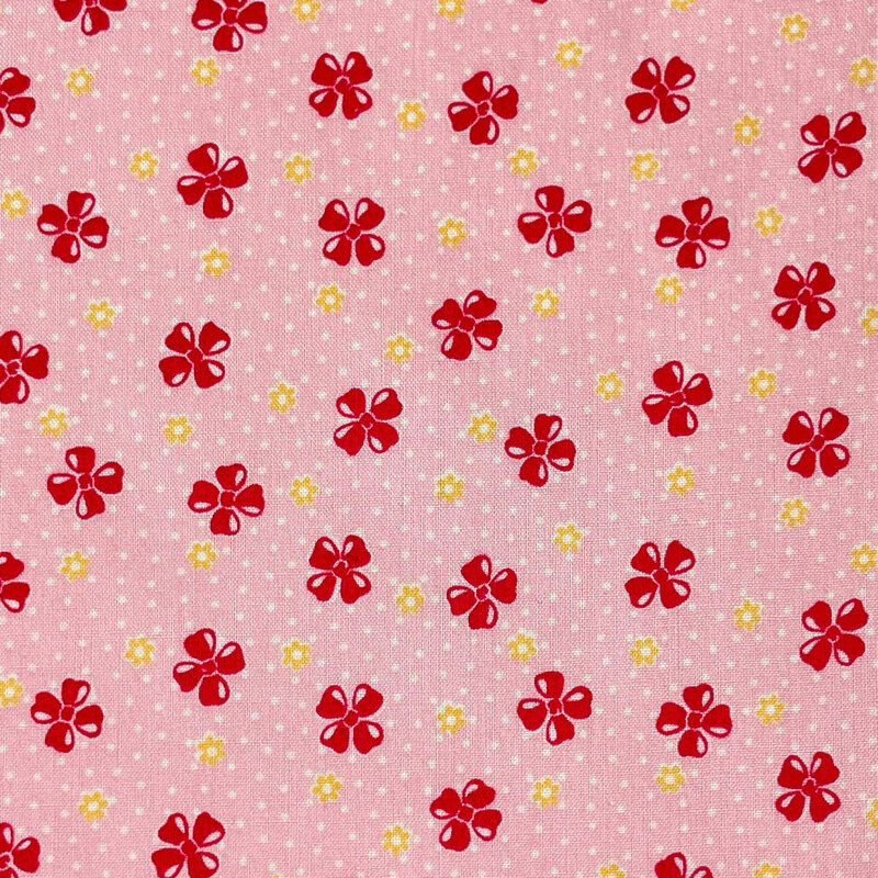 Pink fabric features a vintage-style pattern of floral buds set against a dotted background.