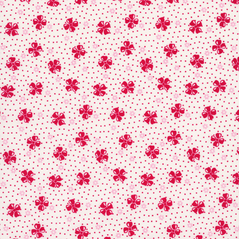 White fabric with a vintage-style pattern of floral buds set against a dotted background.