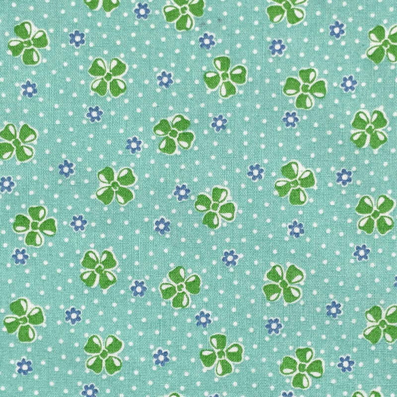Aqua fabric with a vintage-style pattern of floral buds set against a dotted background.