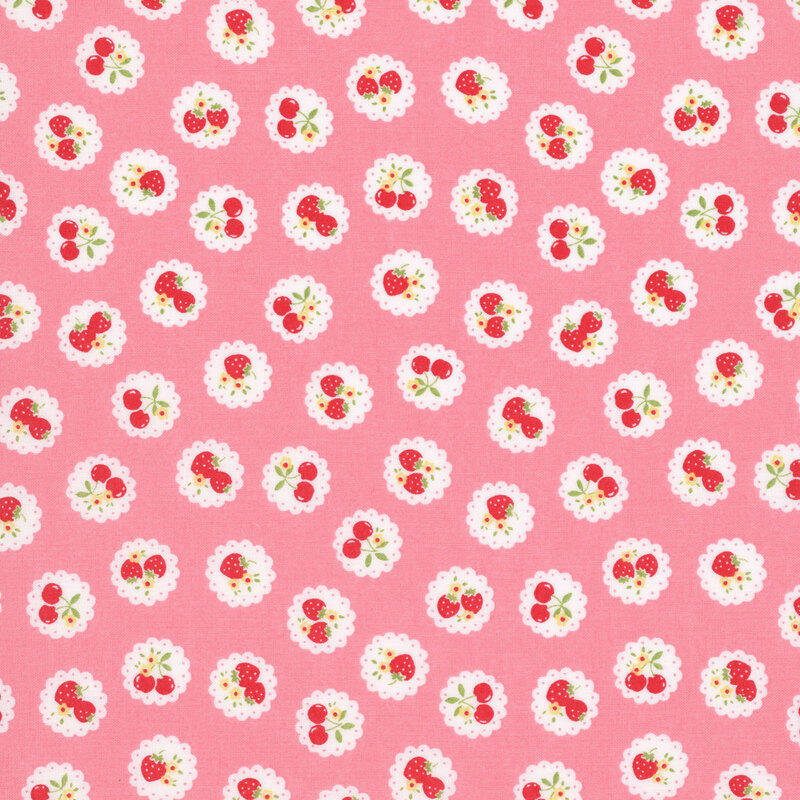 Pink fabric with a pattern of vintage-style medallions filled with assorted fruits like cherries and strawberries.
