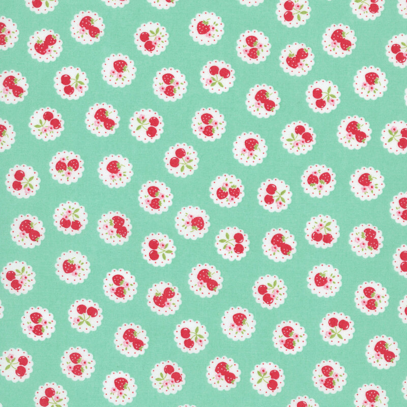 mint green fabric with a pattern of vintage-style medallions filled with assorted fruits like cherries and strawberries.