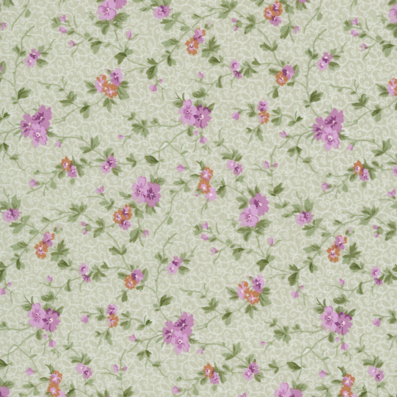 Green fabric with a pattern of stylized florals attached to green leafy vines set against a background of subtle swirls.