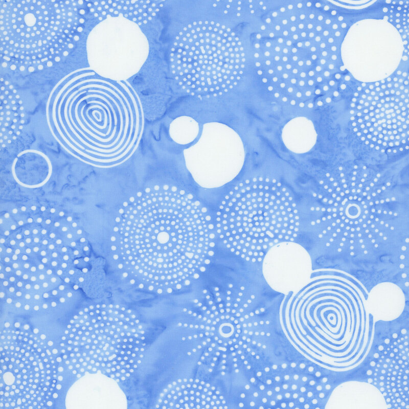 Mottled sky blue batik fabric with a white overlay of spirals, circles, and bursts of dots