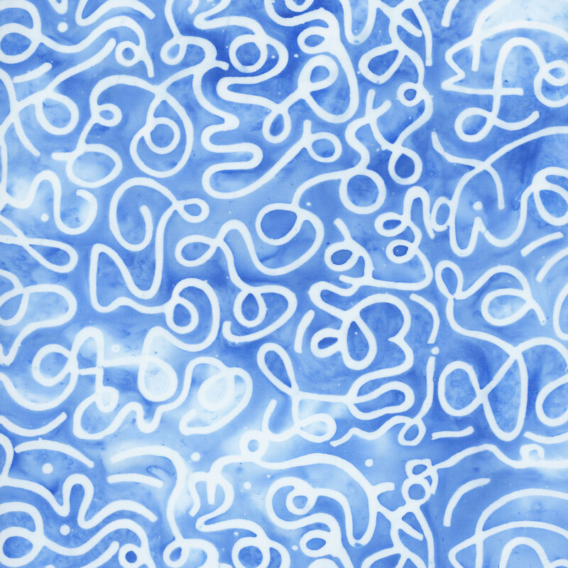 Blue and white mottled batik fabric with an overlay of white squiggles