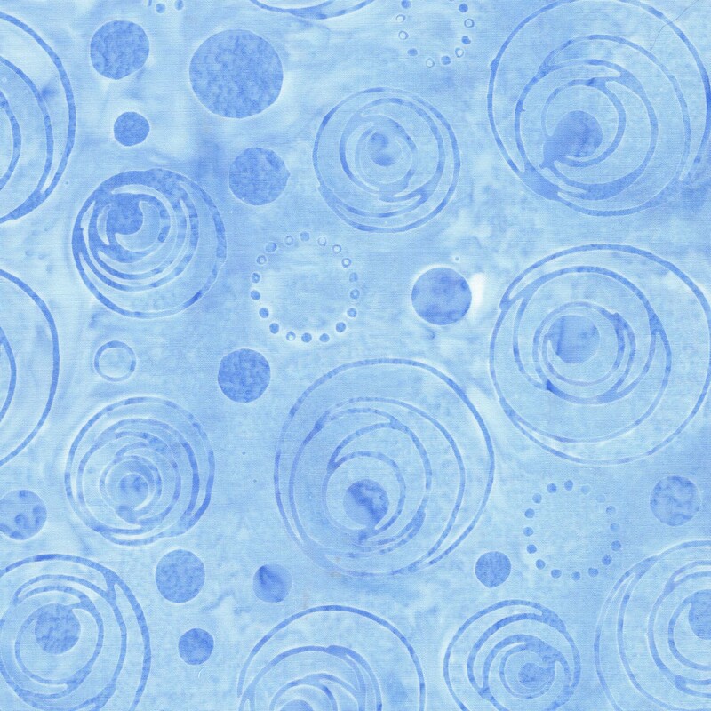 Mottled baby blue batik fabric with a tonal overlay of dots and circles