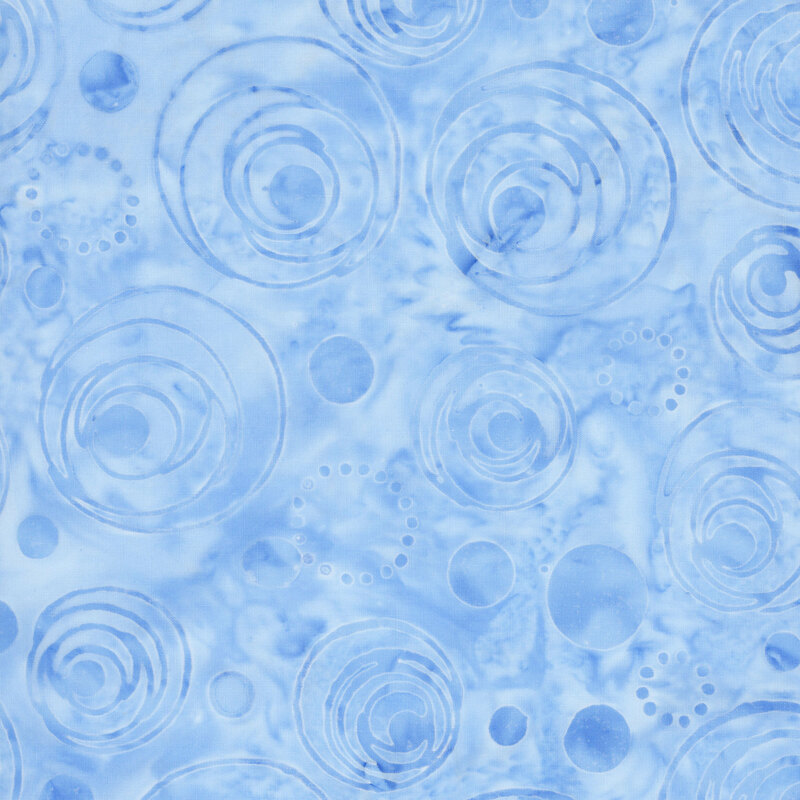 Mottled baby blue batik fabric with a tonal overlay of dots and circles
