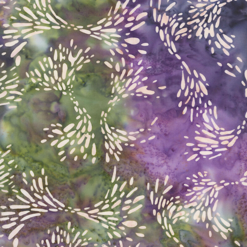 Green and purple watercolor fabric with scattered swirls of petal motifs.