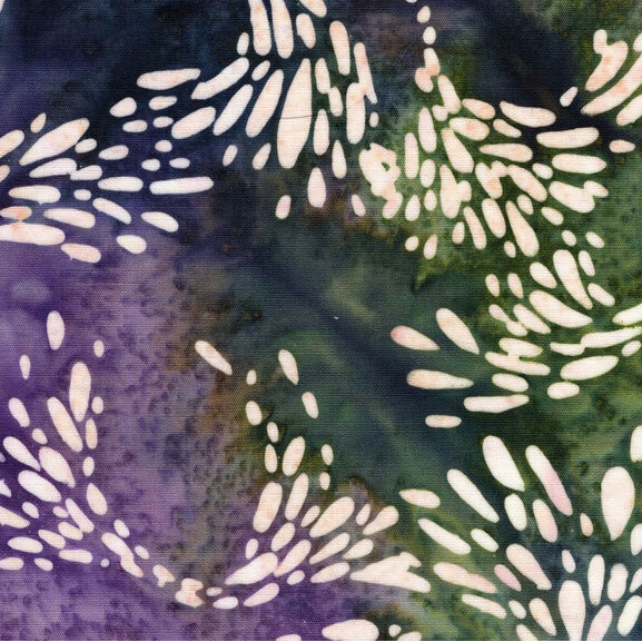 Green and purple watercolor fabric with scattered swirls of petal motifs.