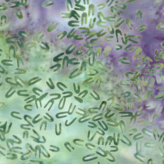 Mottled green and purple fabric with green hairpin shaped motifs scattered throughout.