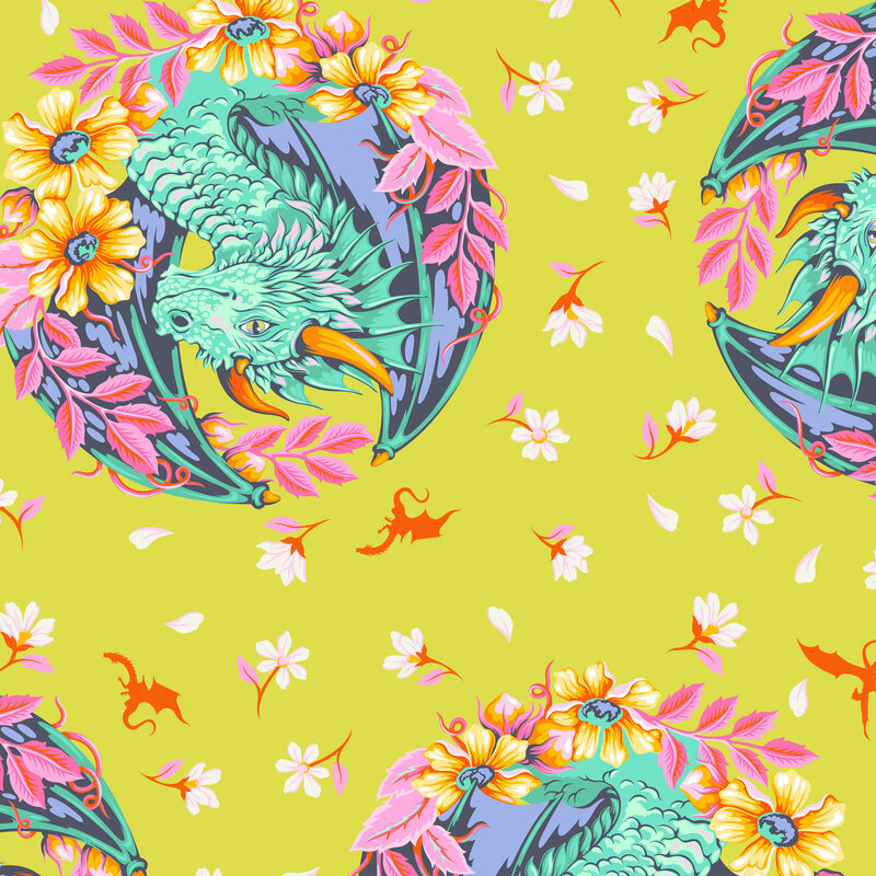 This citrine fabric features portraits of teal dragons framed by pink and orange floral wreaths, with scattered blossoms and dragon silhouettes.