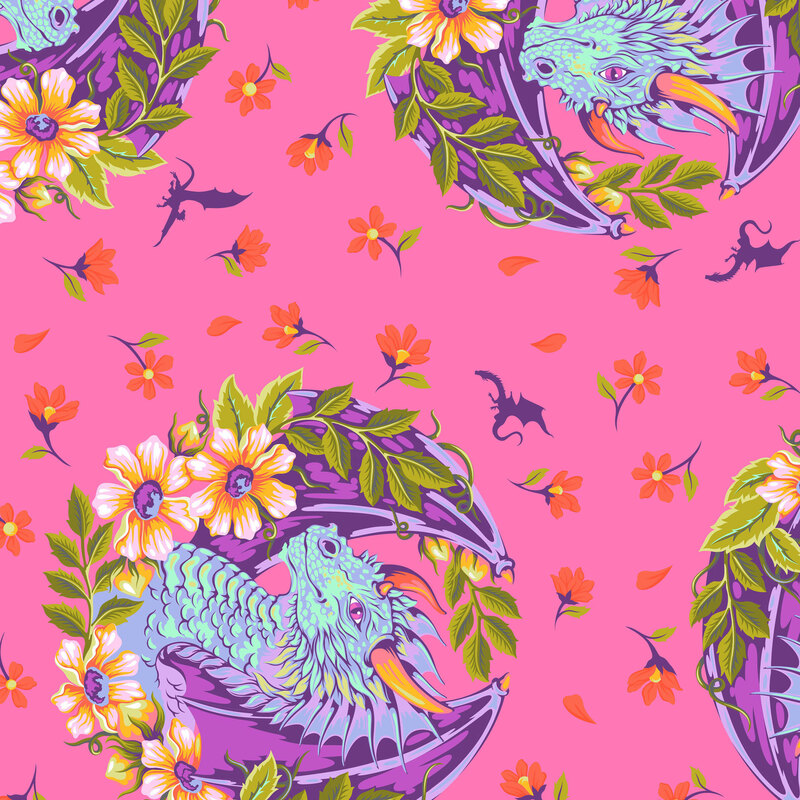 This hot pink fabric features portraits of teal dragons framed by orange and green floral wreaths, with scattered blossoms and dragon silhouettes.