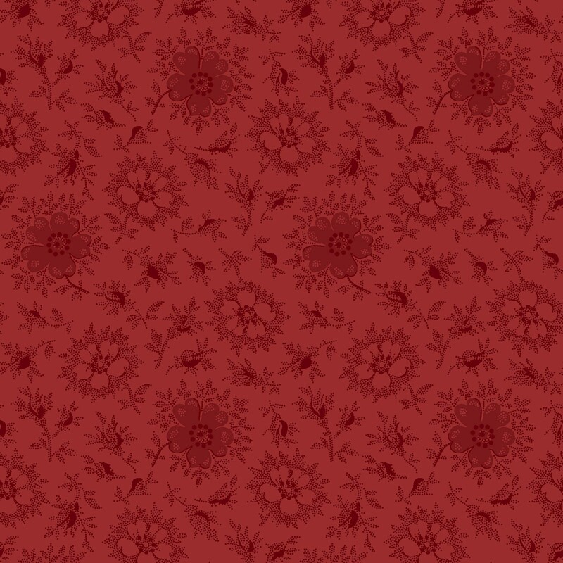 Ruby red fabric with a primitive pattern of light and dark daisies with deep red accents