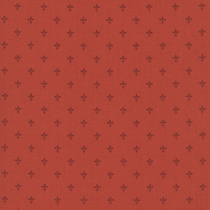 Strawberry red fabric with a pattern of primitive dark red leaf motifs