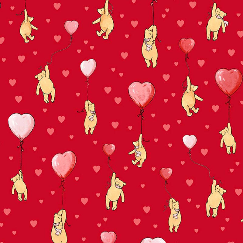 Red fabric with pink hearts and a pattern of Winnie the Pooh's floating with pink heart-shaped balloons