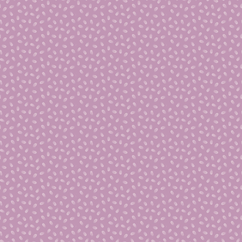 Small pastel pink paint dabs scattered on a dusty pink fabric.