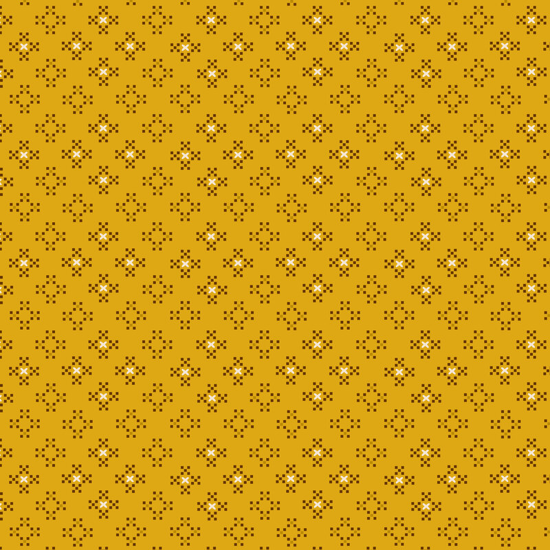 Mustard yellow fabric with staggered grid of pixelated brown crosses and cream cross stitches.