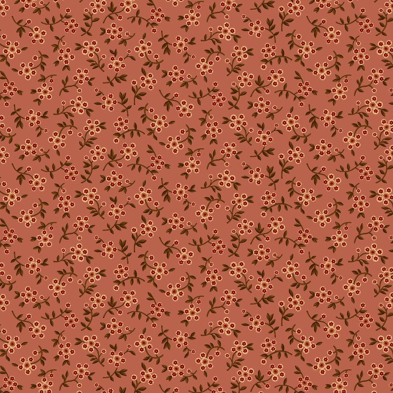 Dusty rose fabric with a tossed pattern of olive green clovers with pastel yellow and ruby red blossoms.