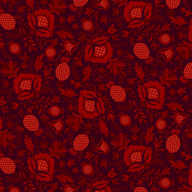 Dark maroon fabric with tossed pattern of tonal bright red pineapple motifs and leaves.