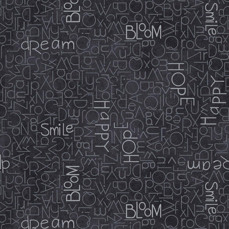 This midnight navy fabric features scattered tonal letters, some spelling out hopeful words like bloom, smile, and dream. 