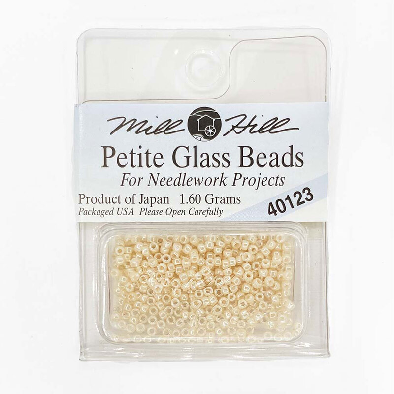 A package of Mill Hill Petite Seed Beads in the color cream. 