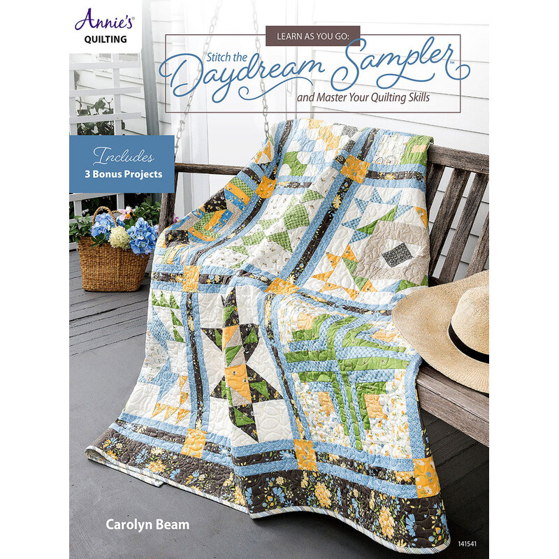 Cover of Stitch the Daydream Sampler quilt book featuring a colorful quilt draped over a chair.