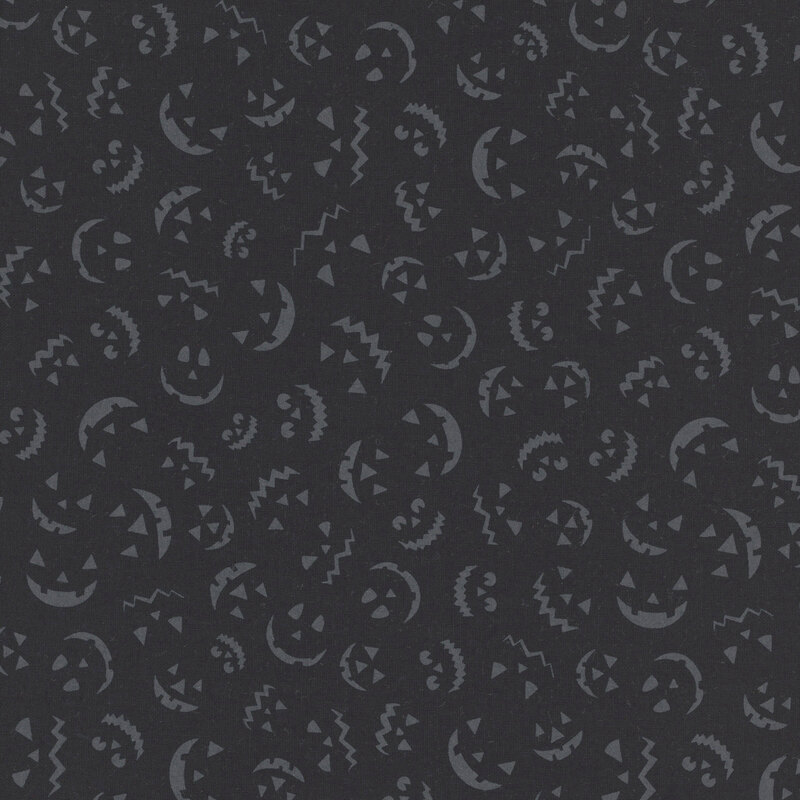 Black fabric featuring tossed gray jack-o-lantern faces.