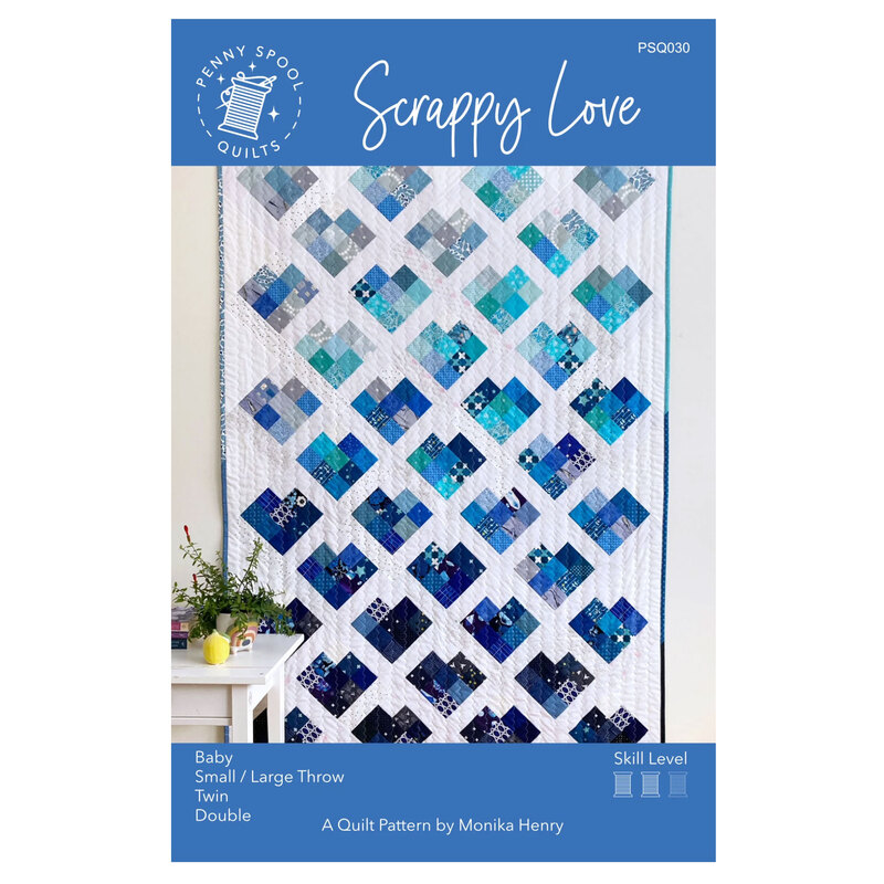 The front of the Scrappy Love pattern showing the finished quilt in blue. 