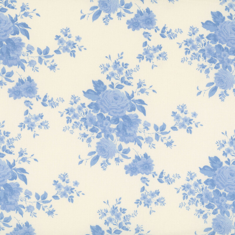 White fabric with floral clusters in a classic toile style, creating an elegant, timeless design.