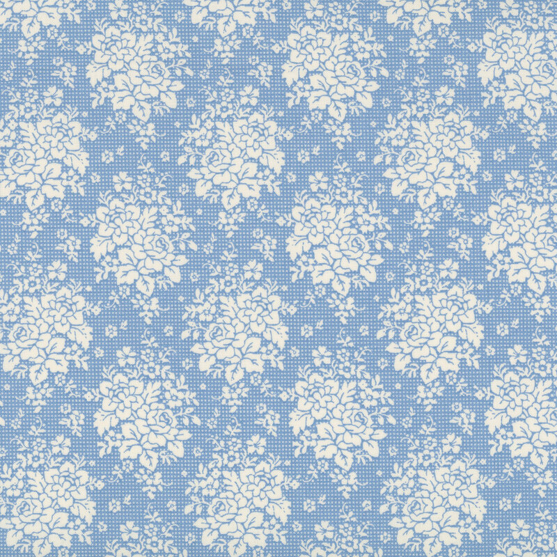 Blue fabric with an geometric pattern of floral clusters and leaves, creating a refined and decorative design.